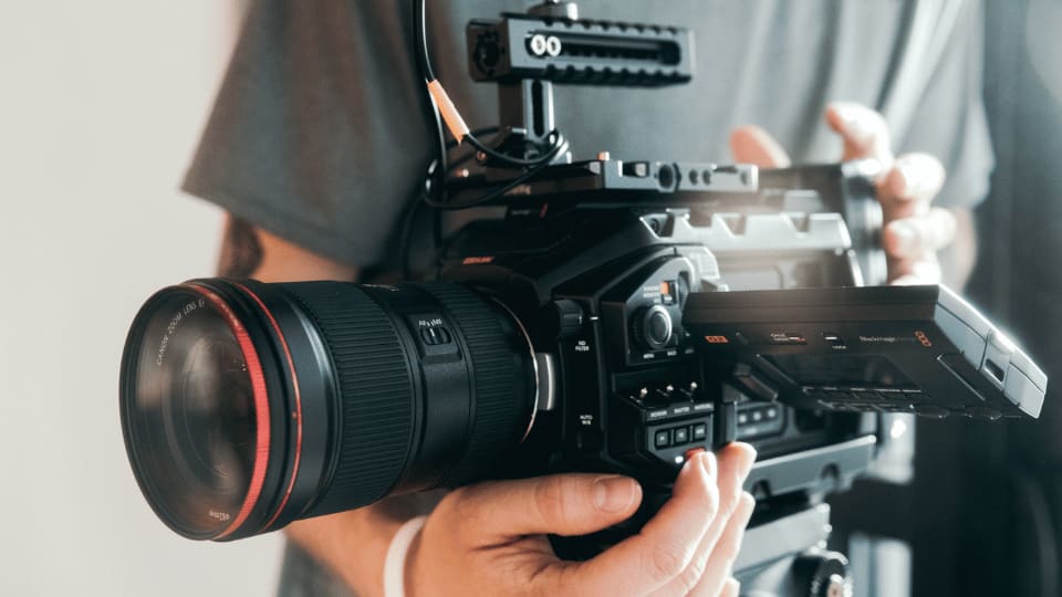 John holding a professional broadcast camera